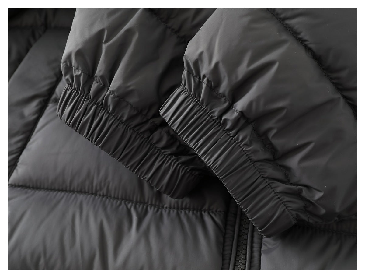 Close-up of the dark gray quilted jacket's sleeve cuffs with gathered elastic edging.