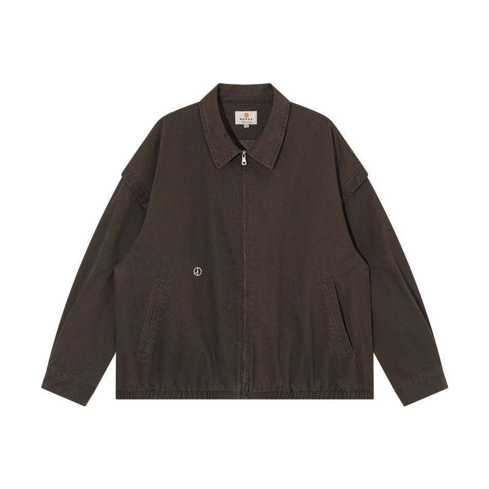 Brown collared zip-front jacket flat lay with angled front pockets, elastic hem and small embroidered peace symbol