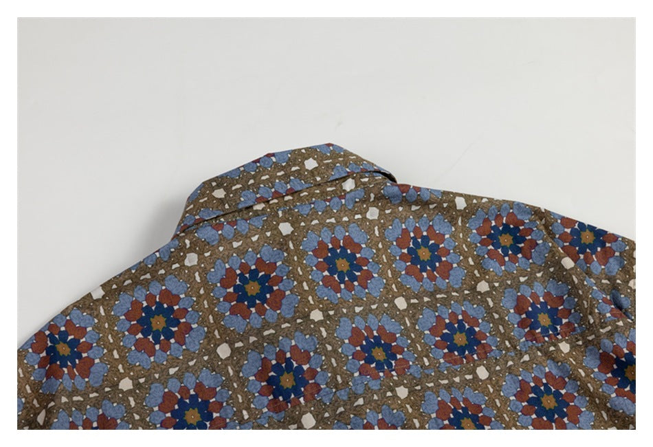 Close-up of the collar and upper back of a brown shirt with blue and rust floral geometric print.