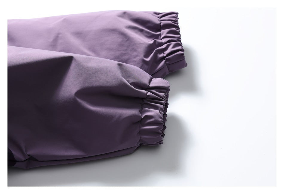 Close-up of a purple jacket sleeve with gathered elastic cuffs.