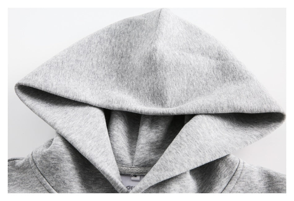 Close-up of a light gray sweatshirt's oversized hood and neckline.