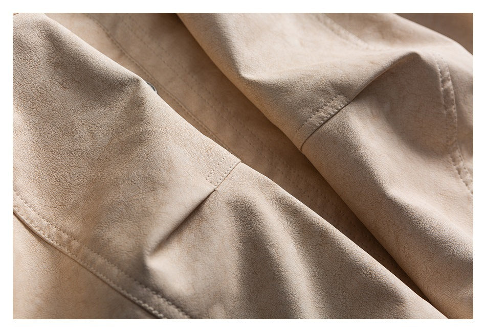 Close-up of beige garment sleeves and seams, showing folded fabric and stitching.