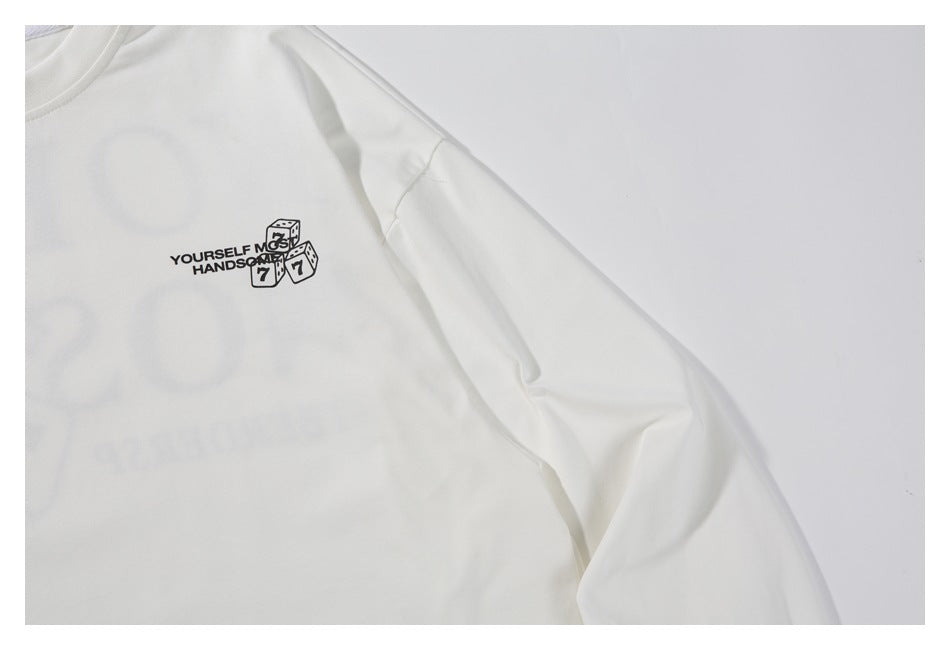 Close-up of the white shirt's chest graphic and long sleeve.