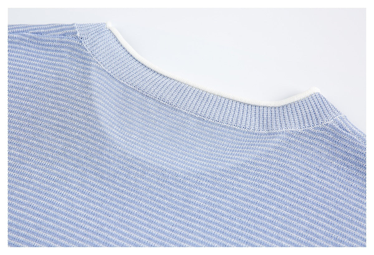 Close-up of a blue-and-white heathered knit crew neckline with ribbed trim.