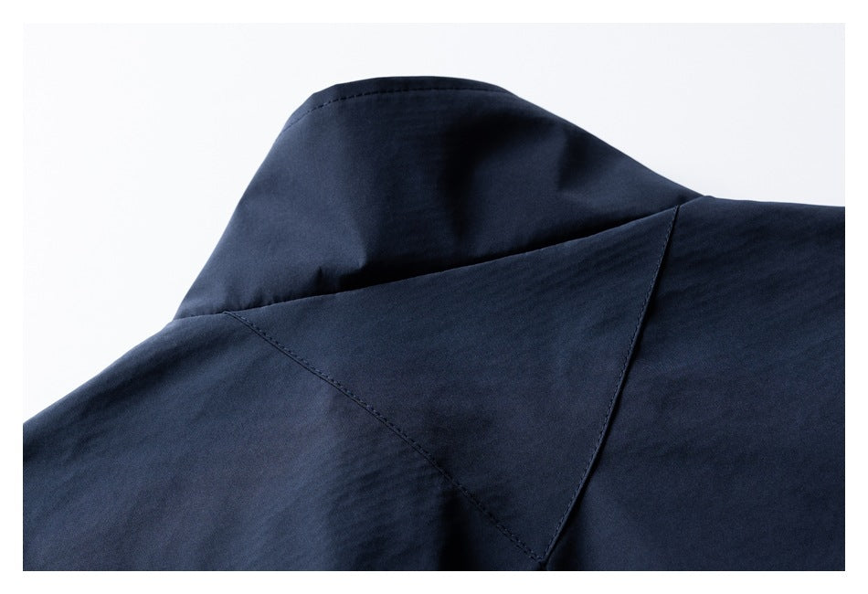 Close-up of the navy jacket's collar and stitched back yoke.