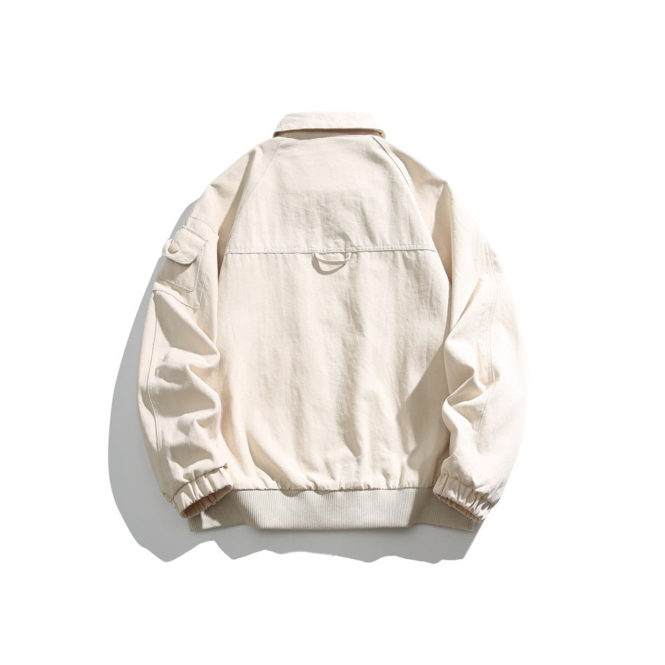 Back view of a cream jacket with a pointed collar, sleeve pocket, elastic cuffs and ribbed hem.