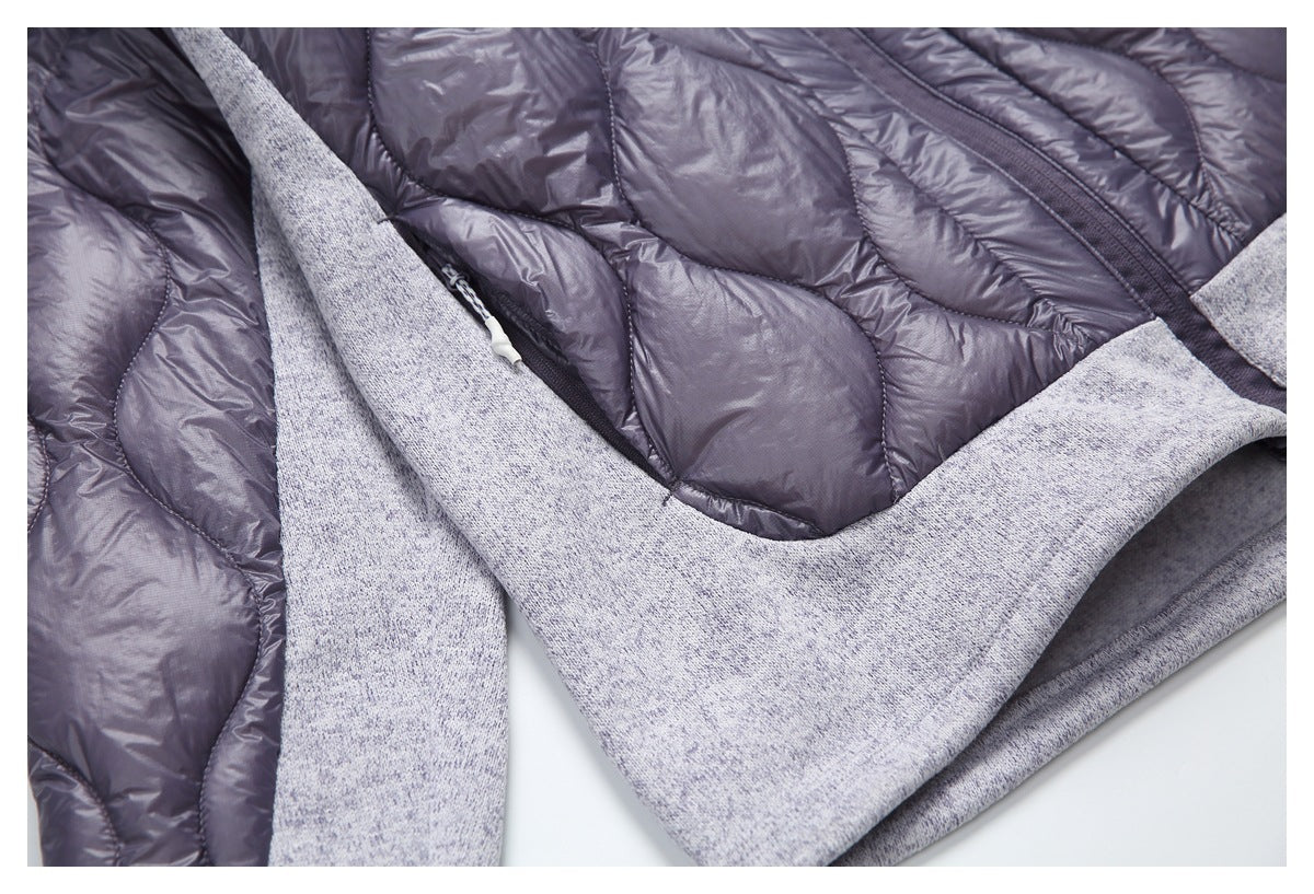 Close-up of the jacket’s quilted shell, knit lower panel, and side pocket zipper.