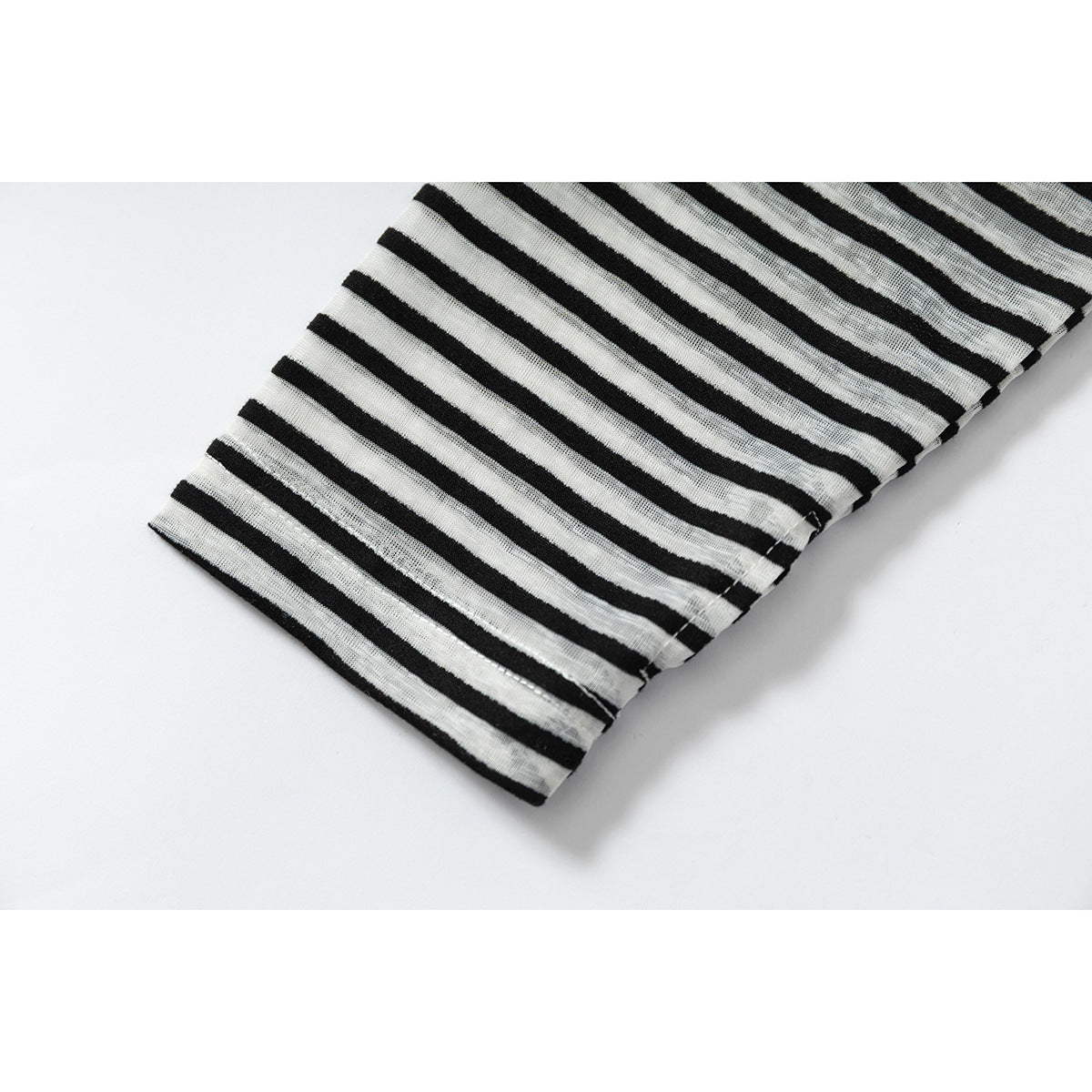 Close-up of the black and gray striped sleeve and stitched hem on a white background.
