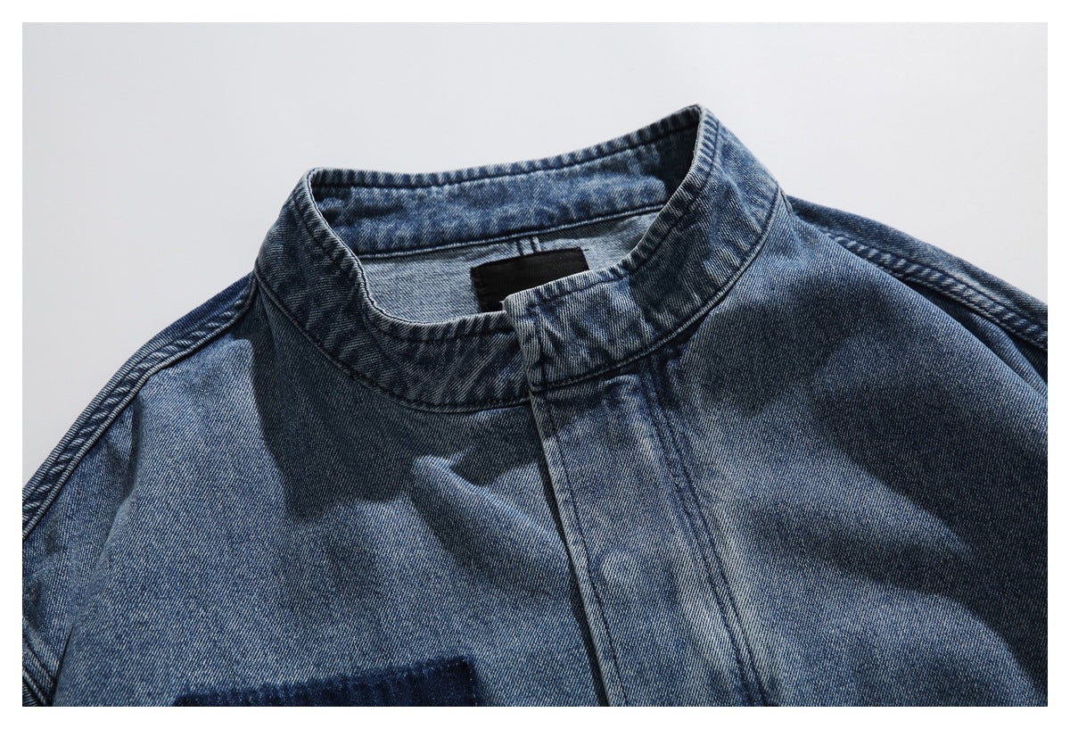Close-up of the washed blue denim jacket's stand collar, neckline and front placket.