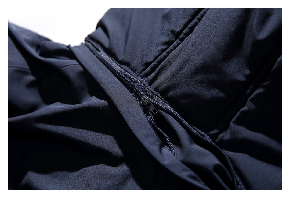 Close-up of a zipper and seam on the dark navy jacket.