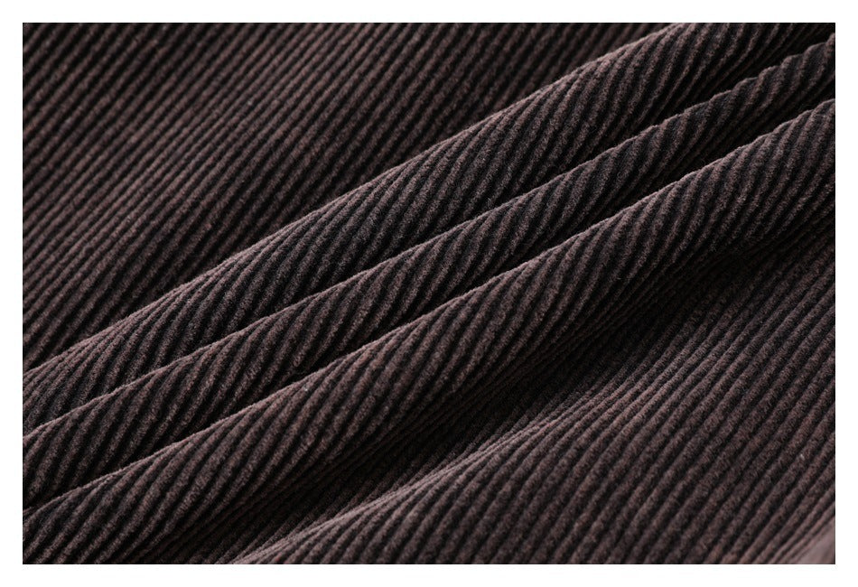 Close-up of dark brown ribbed fabric draped in soft folds.