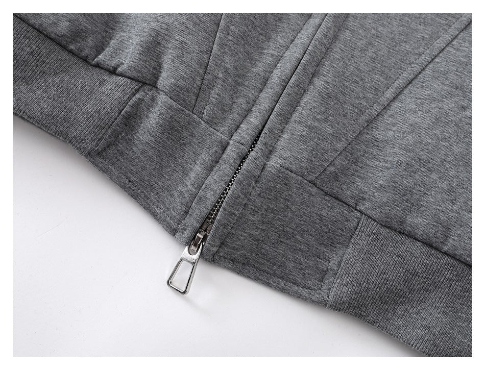 Close-up of a heather-gray jacket's front zipper and ribbed waistband.