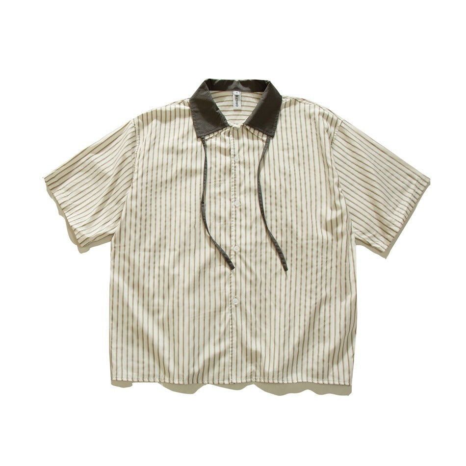 Cream short-sleeve shirt with tan vertical stripes, dark olive collar and two thin straps hanging down the front