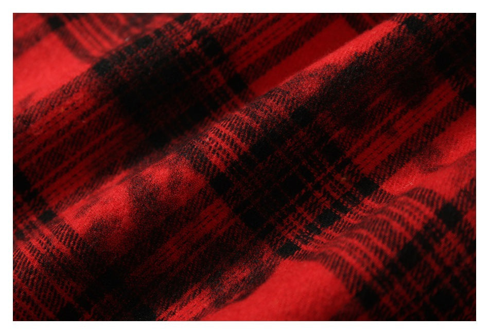 Close-up of red and black plaid fabric with a fuzzy, brushed-looking surface.