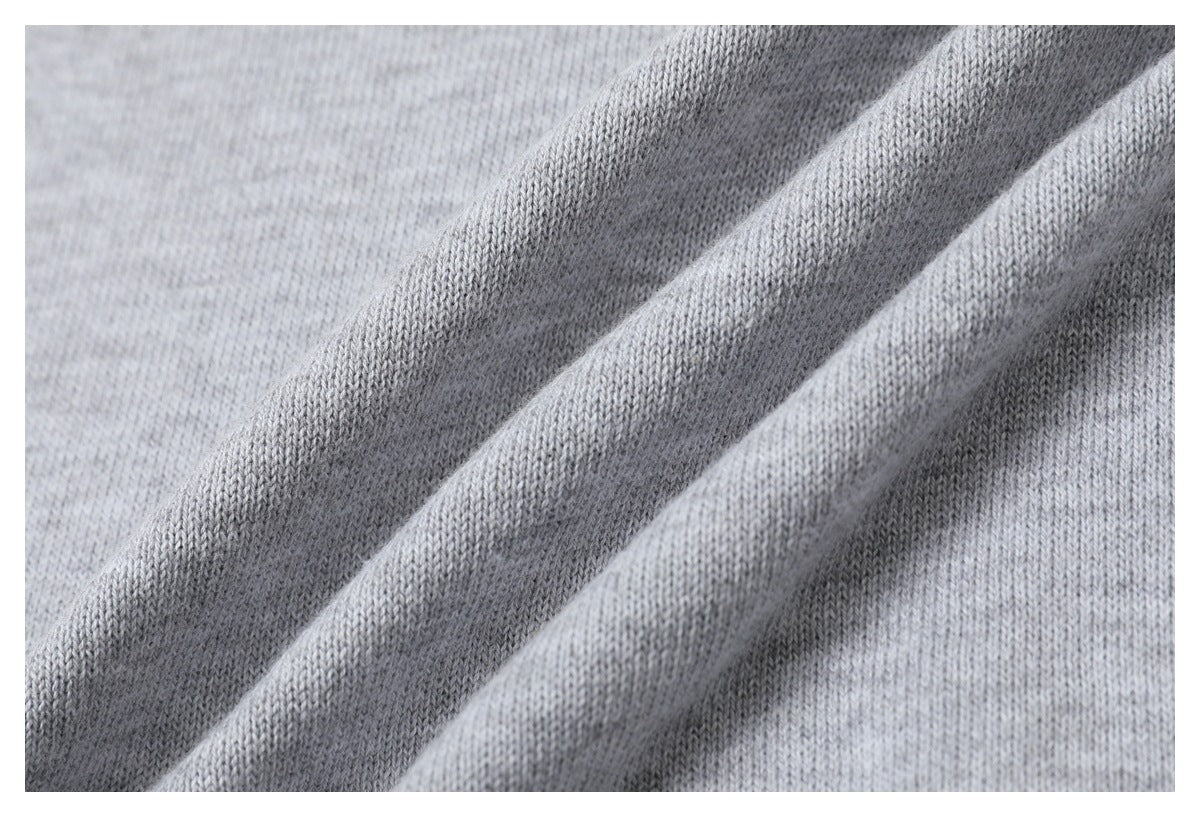 Close-up of the light gray sweater's fine knit fabric gathered into soft folds.