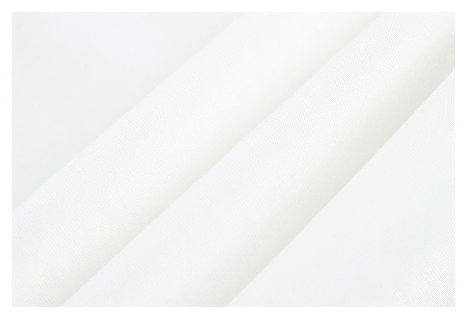 Close-up of white shirt fabric arranged in soft diagonal folds.