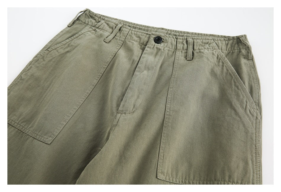 Olive trousers shown from the front, with a button waist, belt loops, angled pockets and large patch pockets.