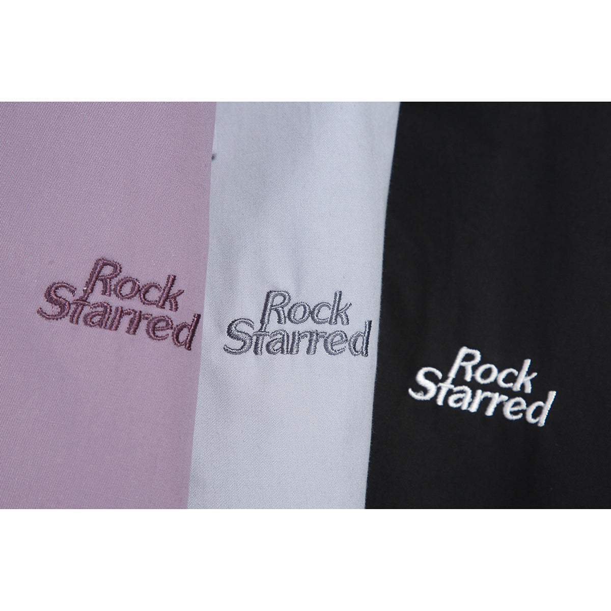 Close-up of embroidered “Rock Starred” lettering on lavender, pale gray, and black fabric.
