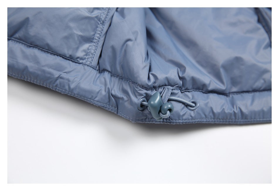 Close-up of the blue-gray jacket hem with an adjustable elastic drawcord and toggle.