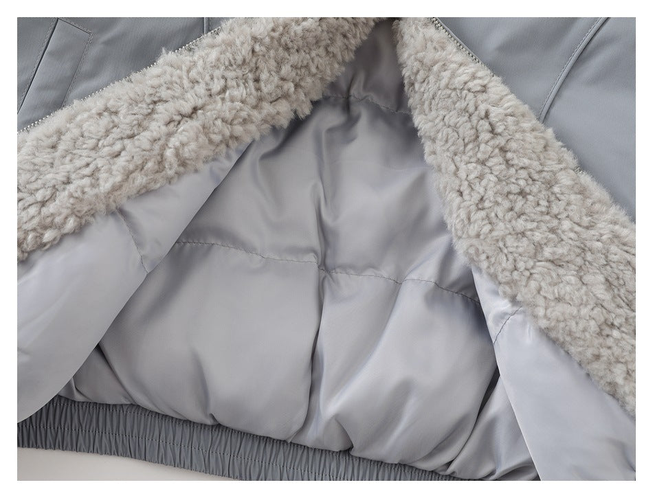 Close-up of a gray jacket interior with plush cream lining and a gathered elastic hem.