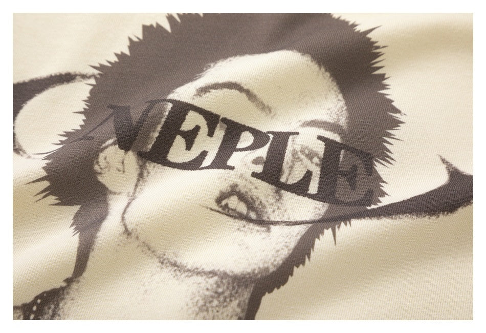 Tight close-up of the garment's printed portrait and English lettering across the face.