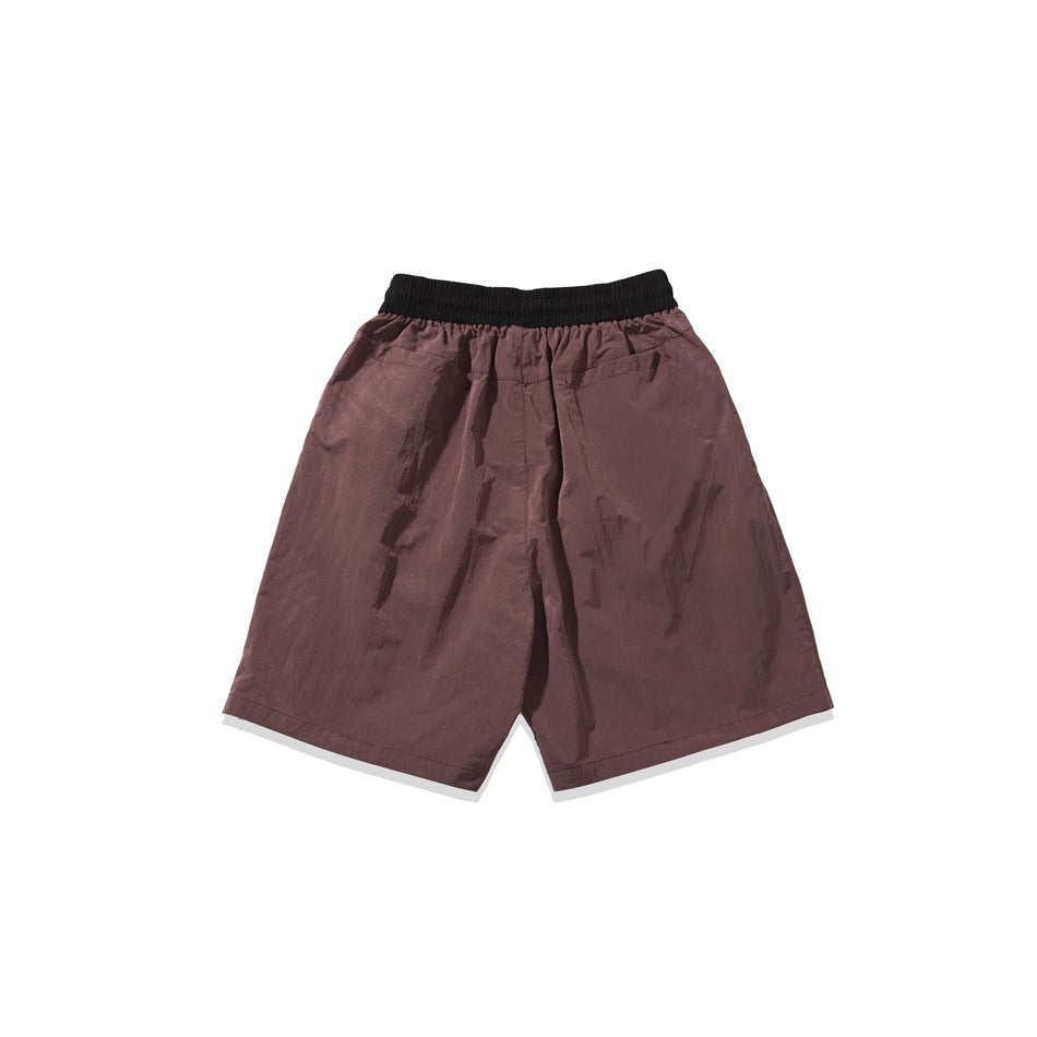 Back view of mauve shorts with a black elastic waistband and two rear pockets.