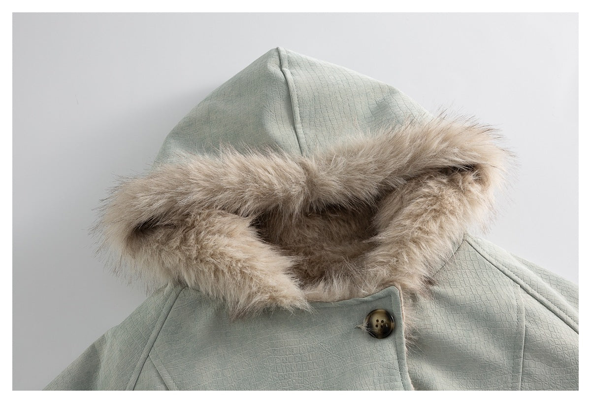 Close-up of the jacket's beige fur-trimmed hood, textured pale sage-gray fabric and large button.