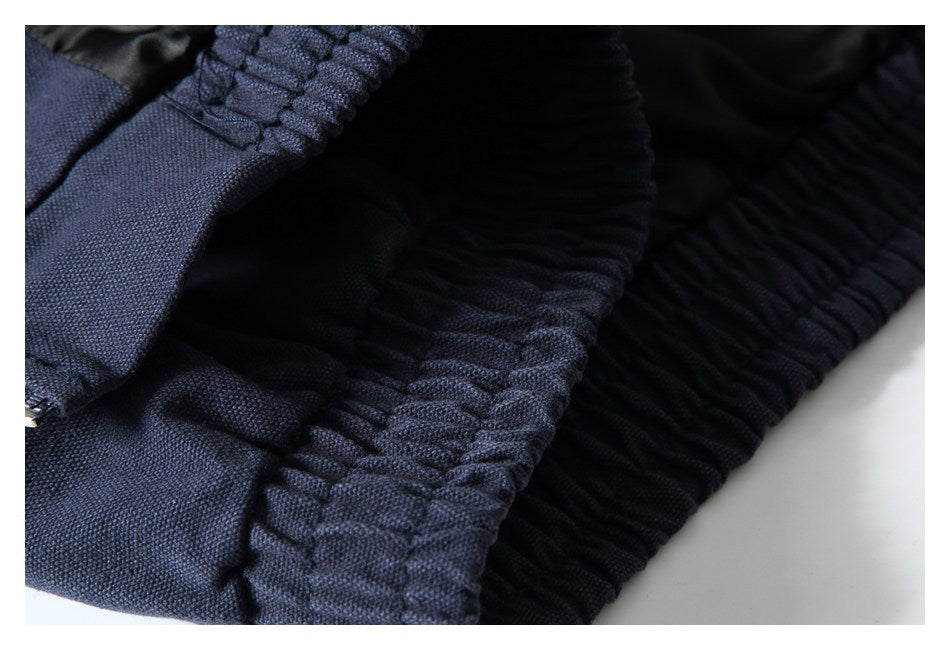 Close-up of a gathered elastic waistband on dark navy garment fabric.
