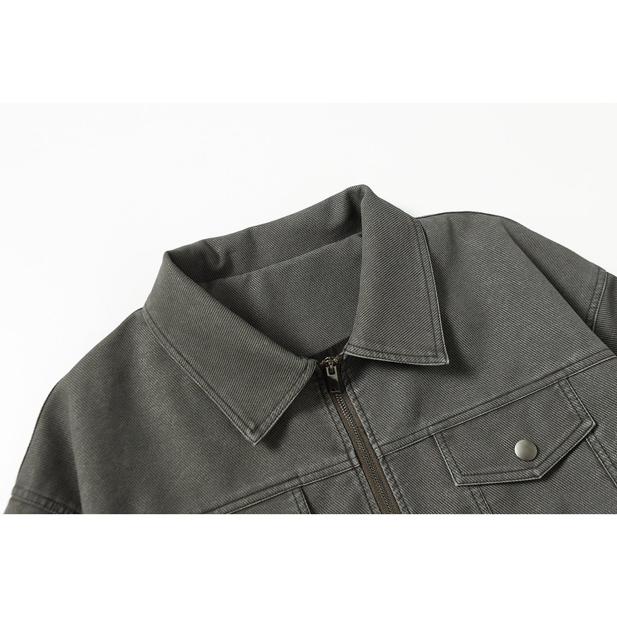 Close-up of a charcoal gray jacket collar, front zipper, and flap chest pocket with a metal snap.