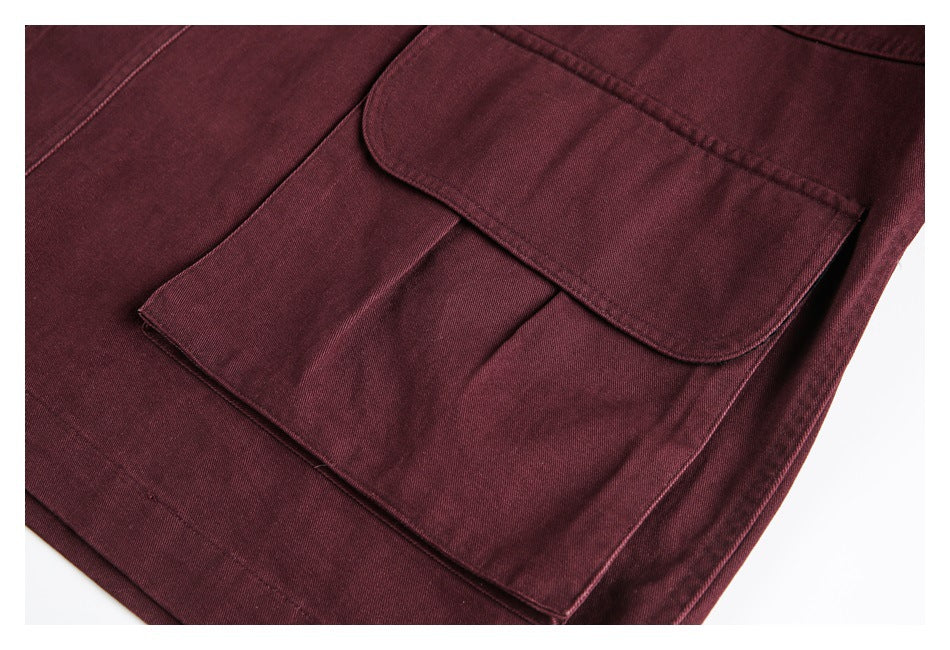 Close-up of a burgundy jacket with a flap over a large patch pocket.