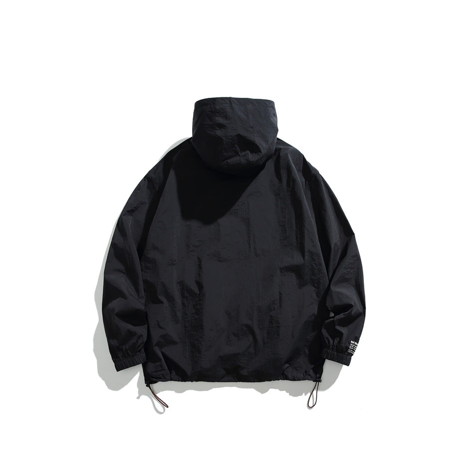 Back view of a dark hooded jacket displayed flat, with elastic cuffs and adjustable drawcords at the hem.