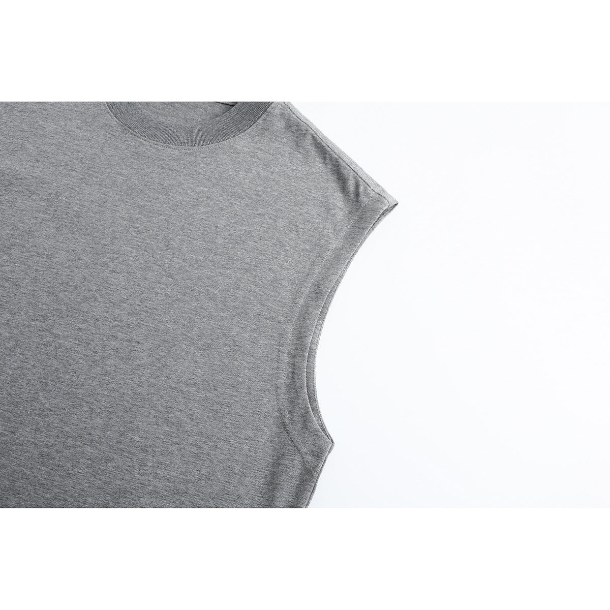 Close-up of the armhole and upper front of a heather gray sleeveless top.