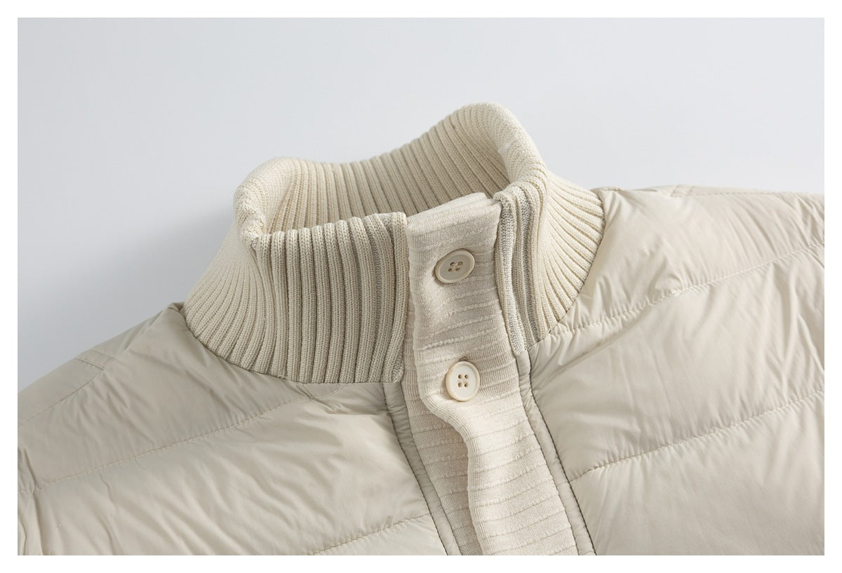Close-up of a cream jacket’s ribbed stand collar and two-button knit placket beside its quilted body.