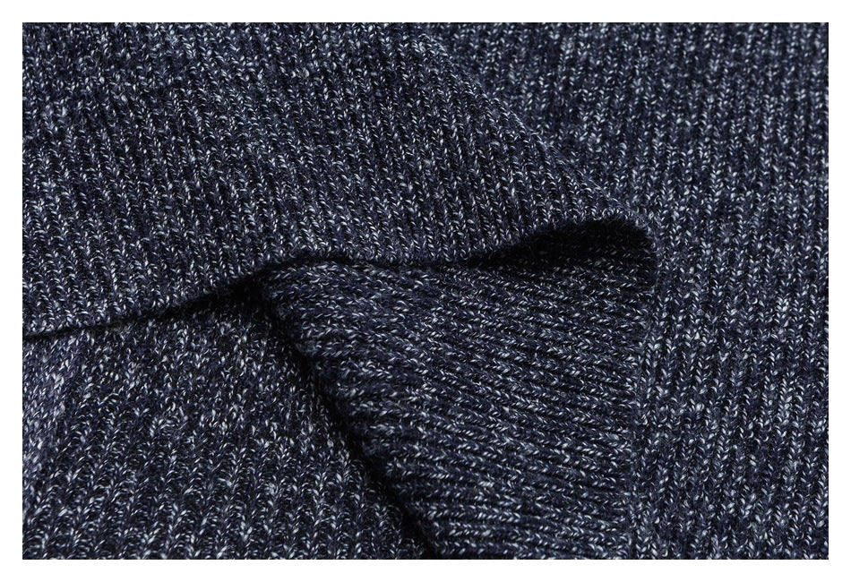 Close-up of a folded ribbed section of dark navy marled knitwear.