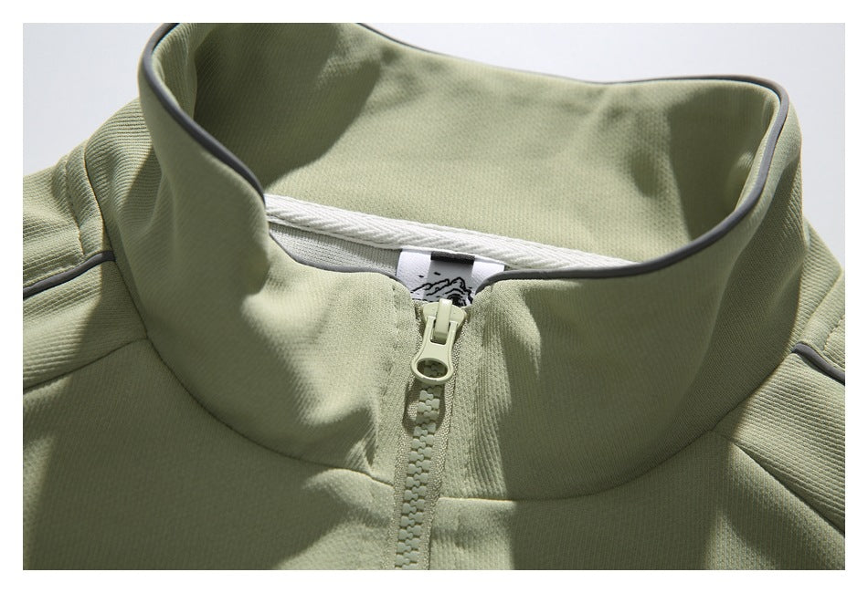 Close-up of the jacket’s stand collar, inner neck label, and pale front zipper.