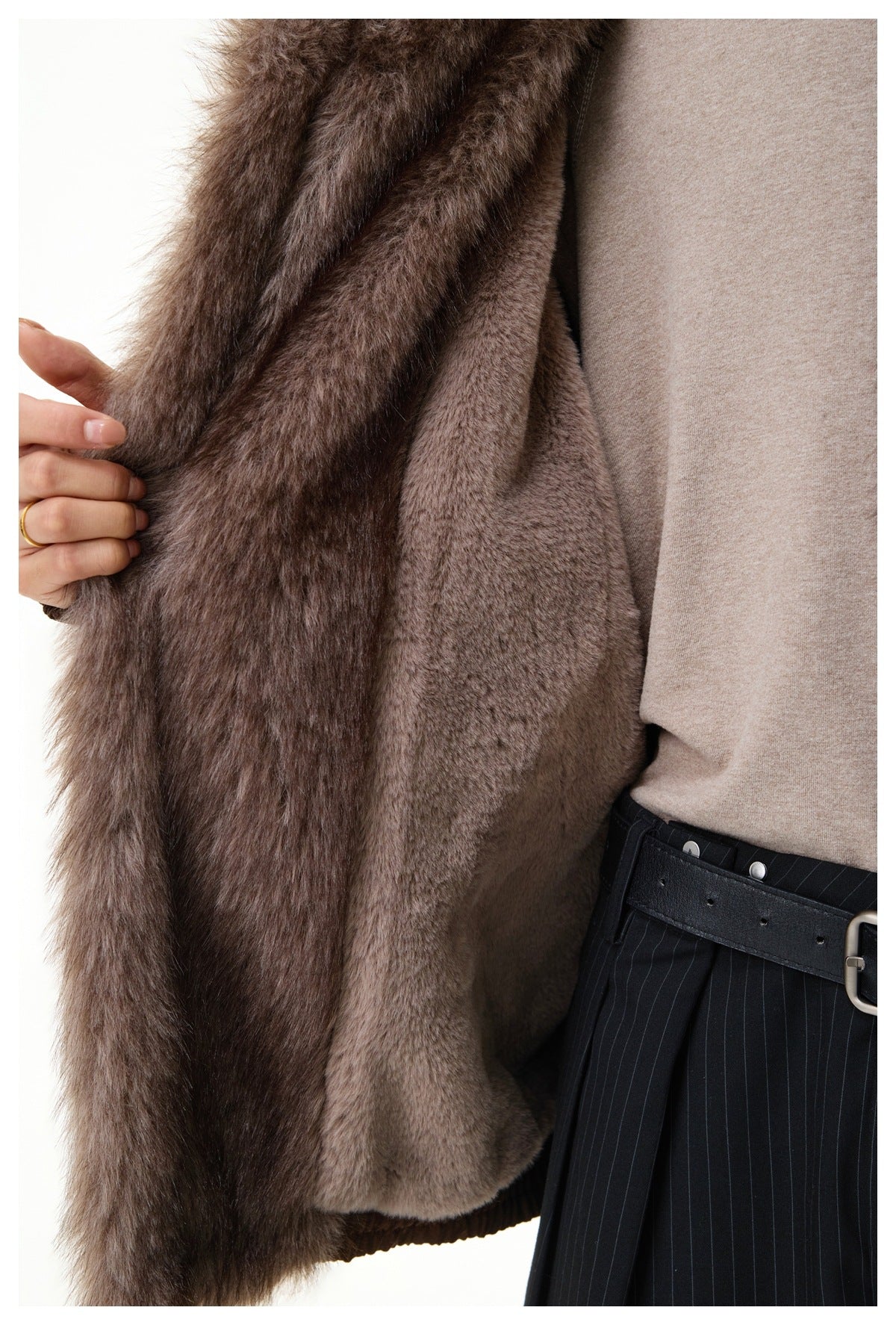 Close-up of the jacket's plush gray-brown faux-fur collar and inner trim beside the brown outer fabric.