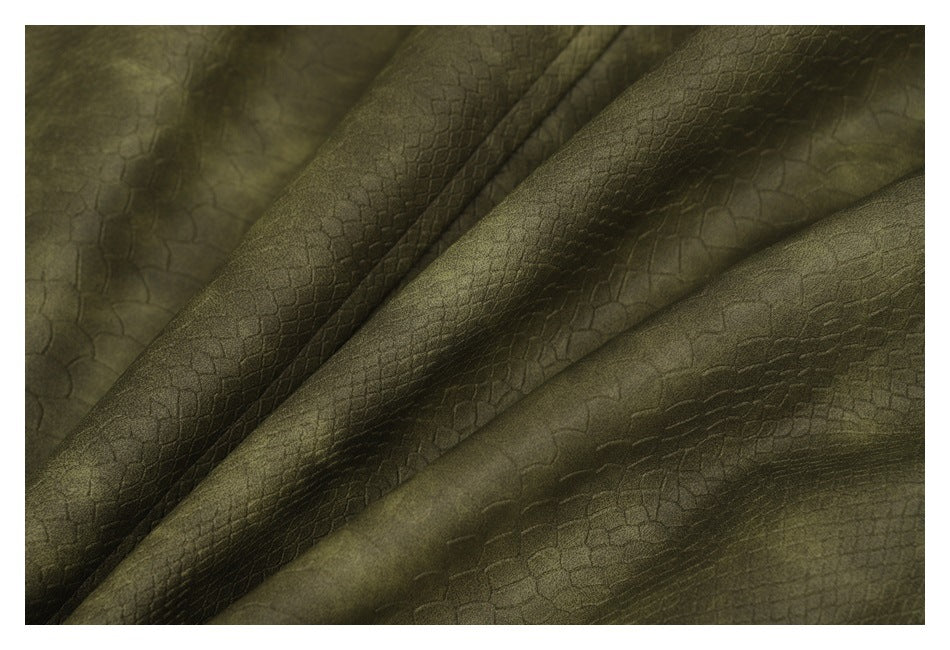 Close-up showing the olive-green fabric's subtle reptile-scale texture and tonal variation.