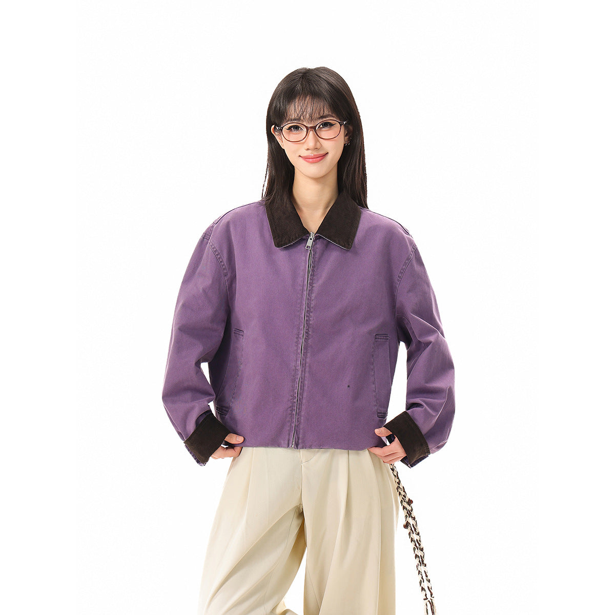 Front view of a model in a lavender cropped zip jacket with dark collar and cuffs.