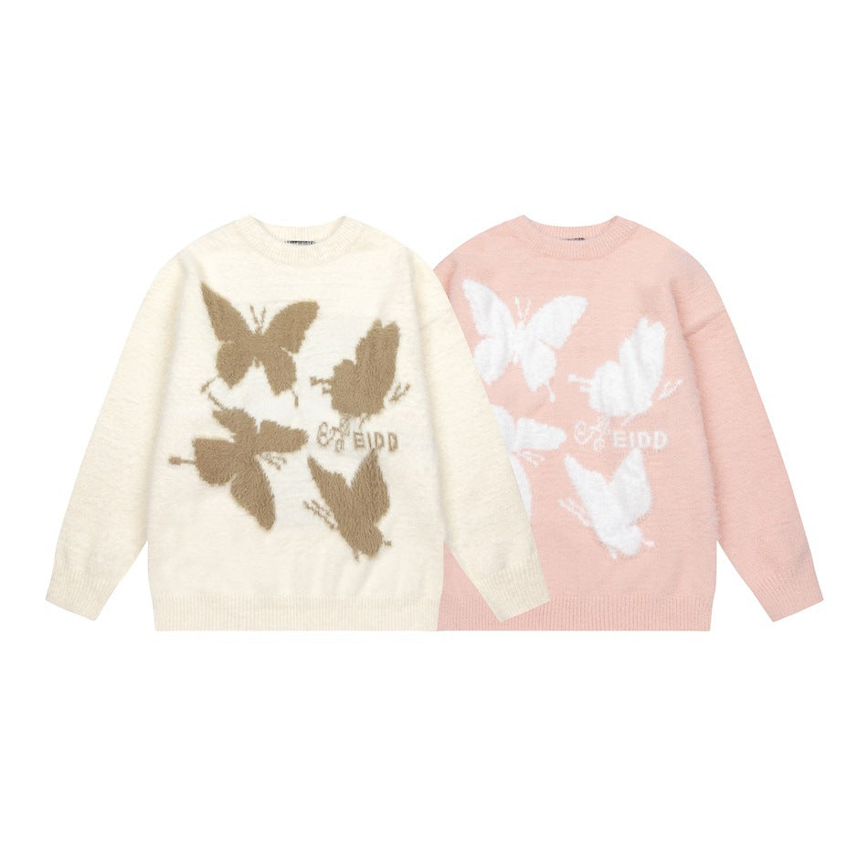 Ivory and pale pink crewneck sweaters with contrasting butterfly motifs, shown side by side.