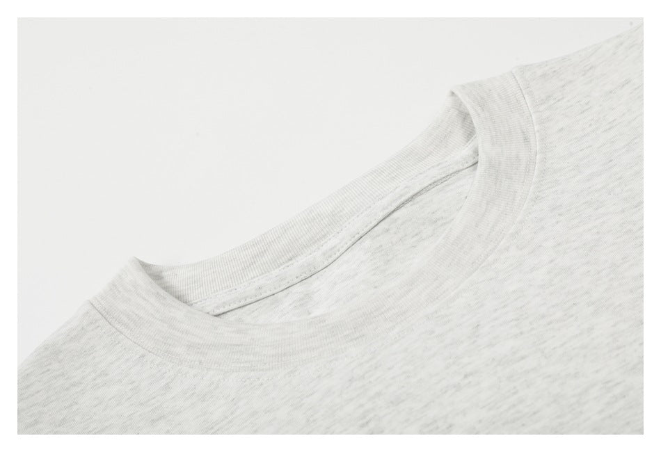 Close-up of the ribbed crew neckline on a light gray marled T-shirt.