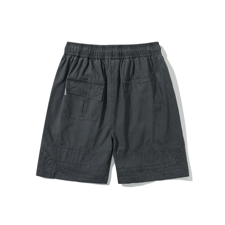 Back view of charcoal drawstring shorts with an elastic waistband, one flap pocket, and one welt pocket.