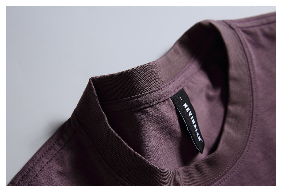 Close-up of a plum-purple shirt neckline with ribbed collar and a black woven label.