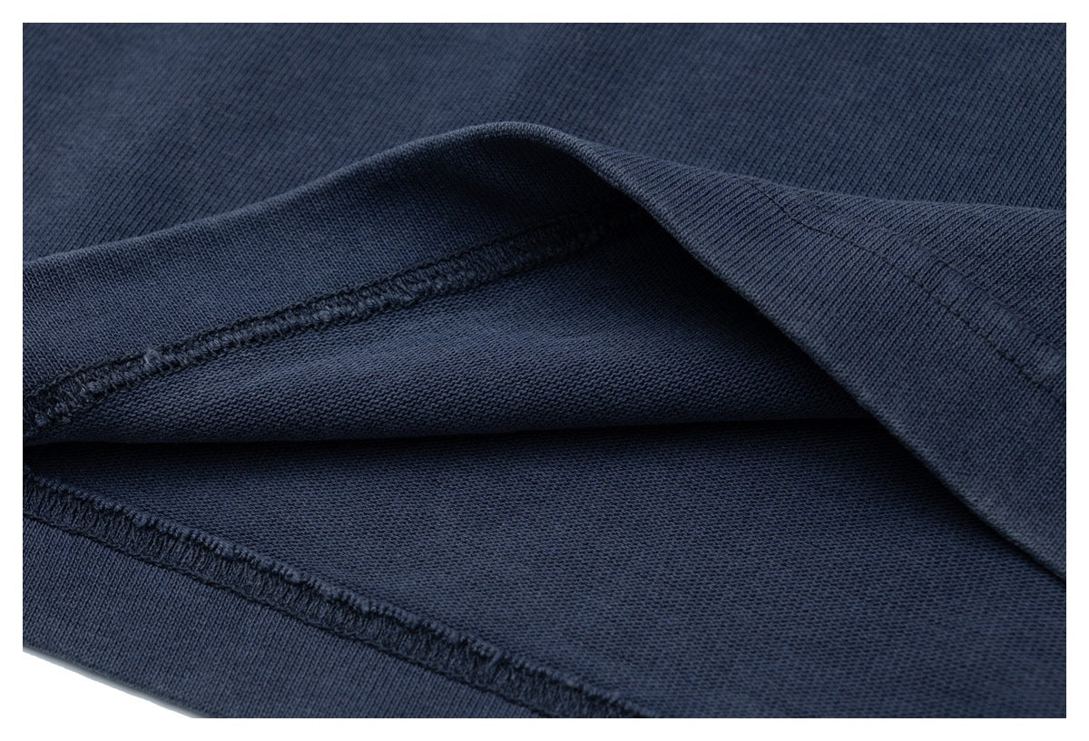 Close-up of the inside stitching and seams of dark navy fabric.