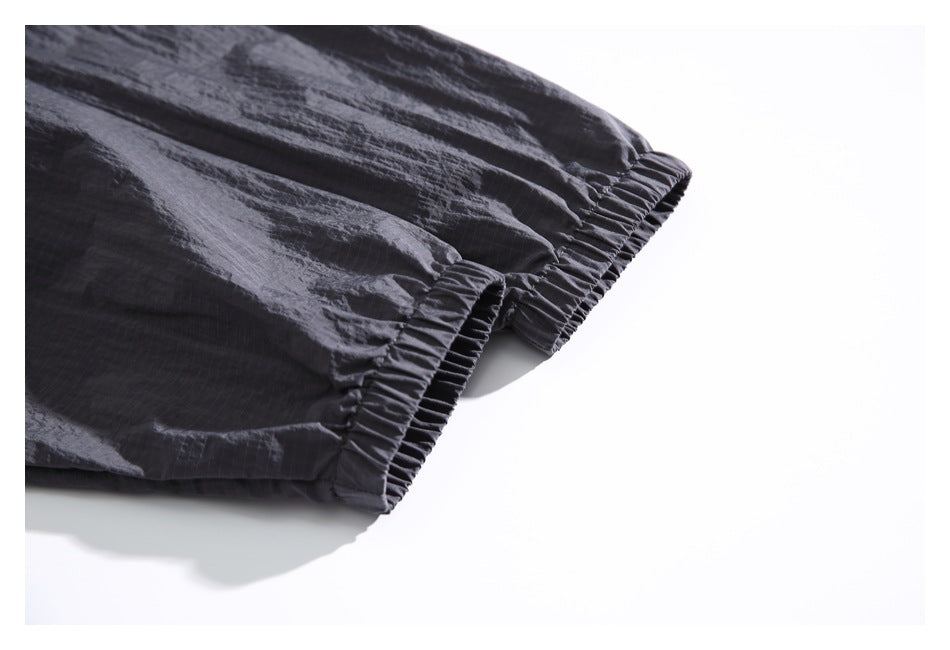 Close-up of a charcoal jacket sleeve with a gathered elastic cuff.