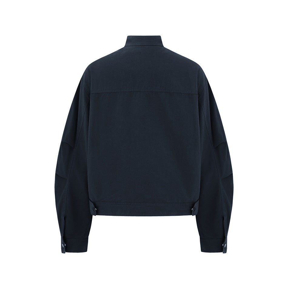 Back view of a navy jacket with a stand collar, long sleeves, and snap-adjustable hem tabs.