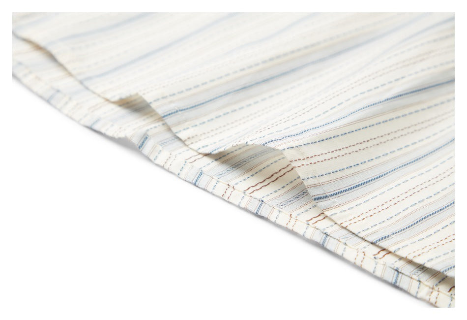 Close-up of a stitched hem on cream fabric with fine blue and brown stripes.