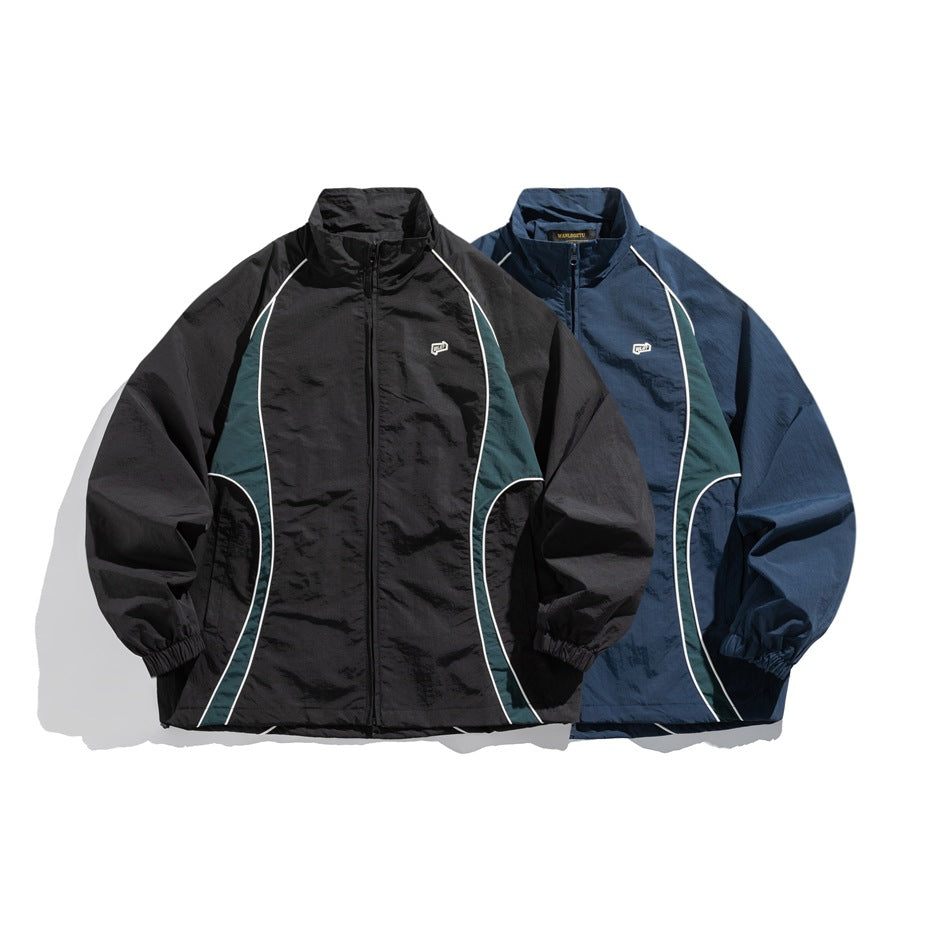 Two zip-up jackets shown from the front: one black and one navy, both with dark green panels and white piping.
