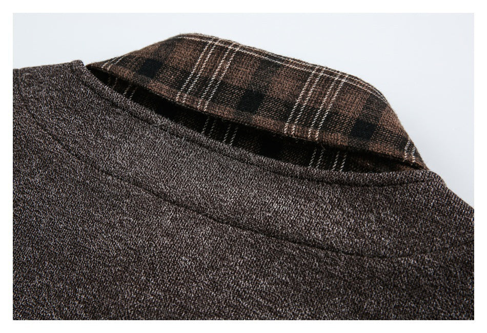 Close-up of a dark brown textured garment neckline with a brown plaid inner collar.