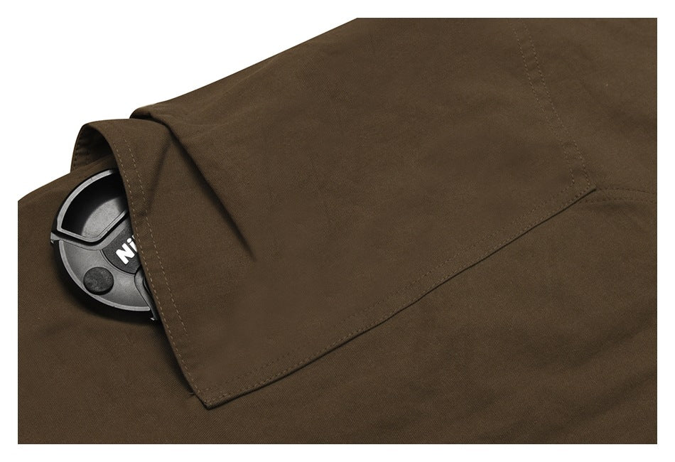 Close-up of an olive-brown cargo pocket with a dark round object tucked inside.