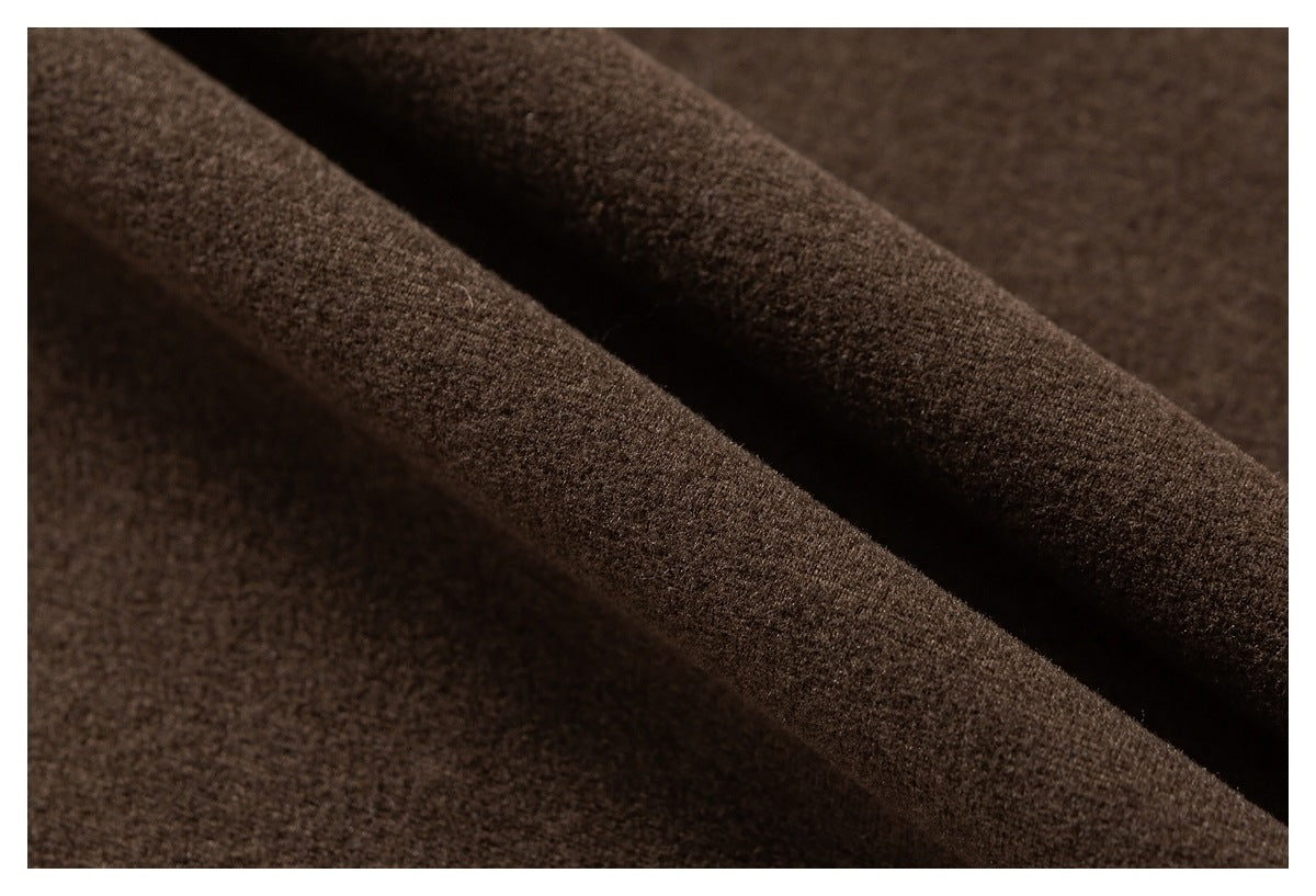 Macro view of the brown garment's soft-looking knit surface and folded fabric.